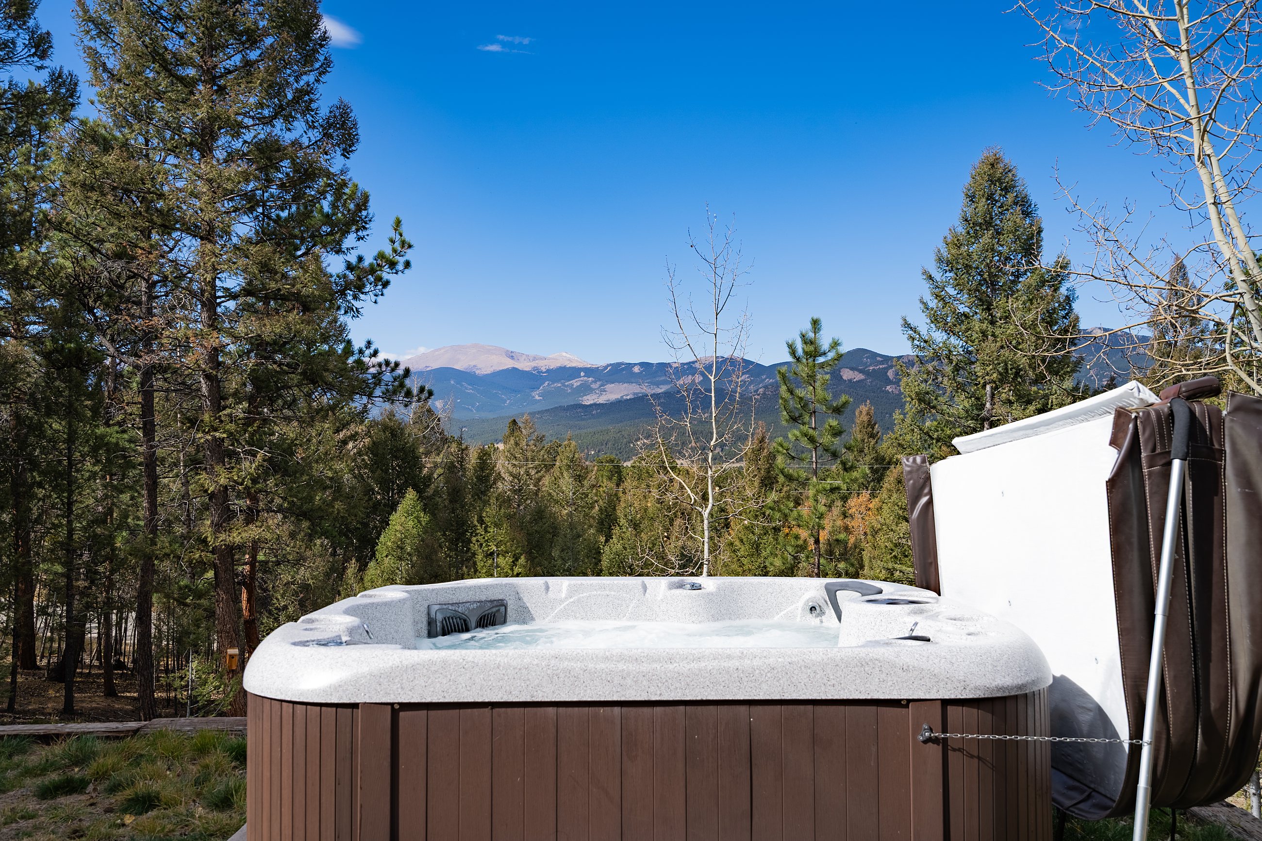 Twilight deck with hot tub overlooking the mountains