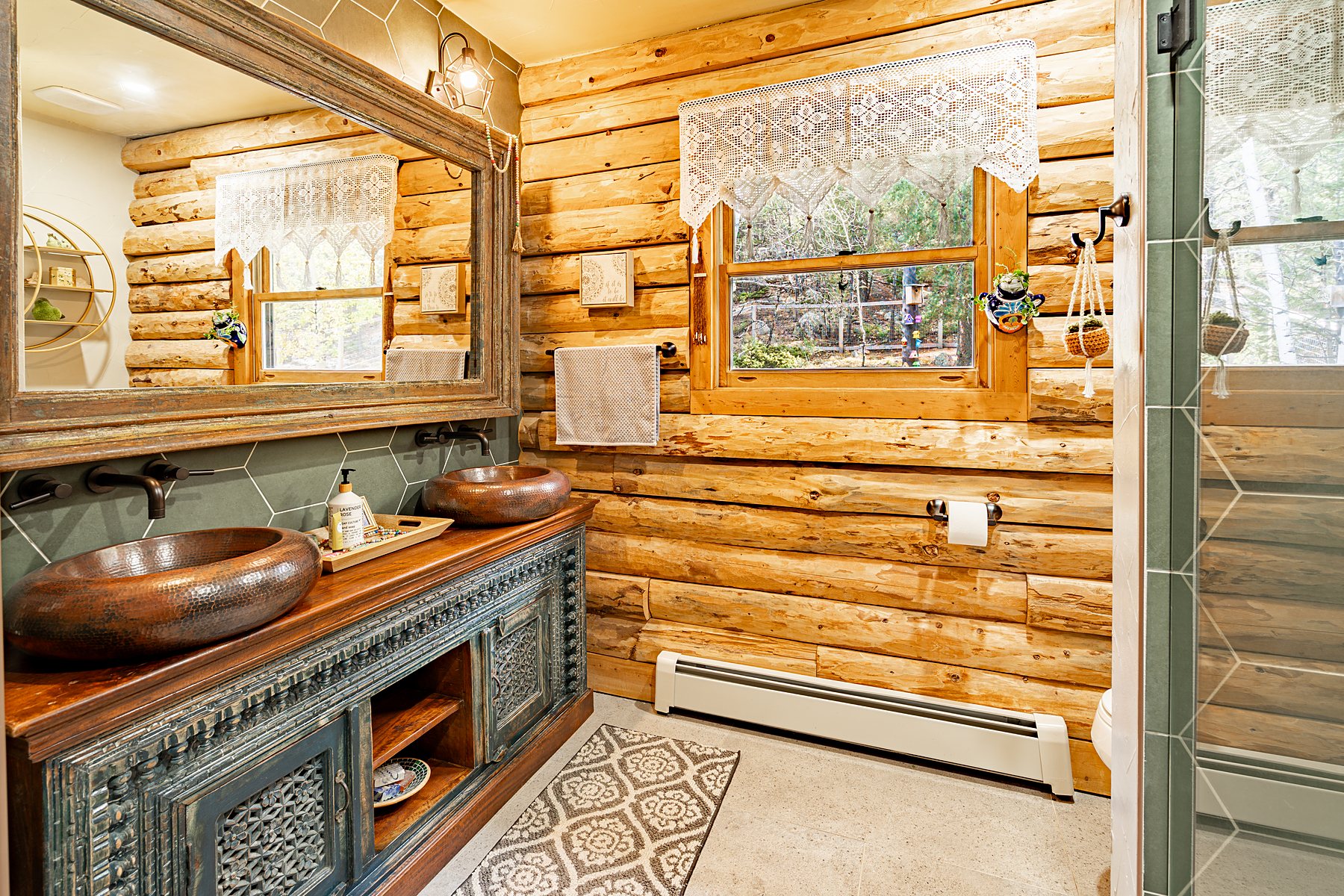 Log cabin kitchen with wood ceiling and warm light