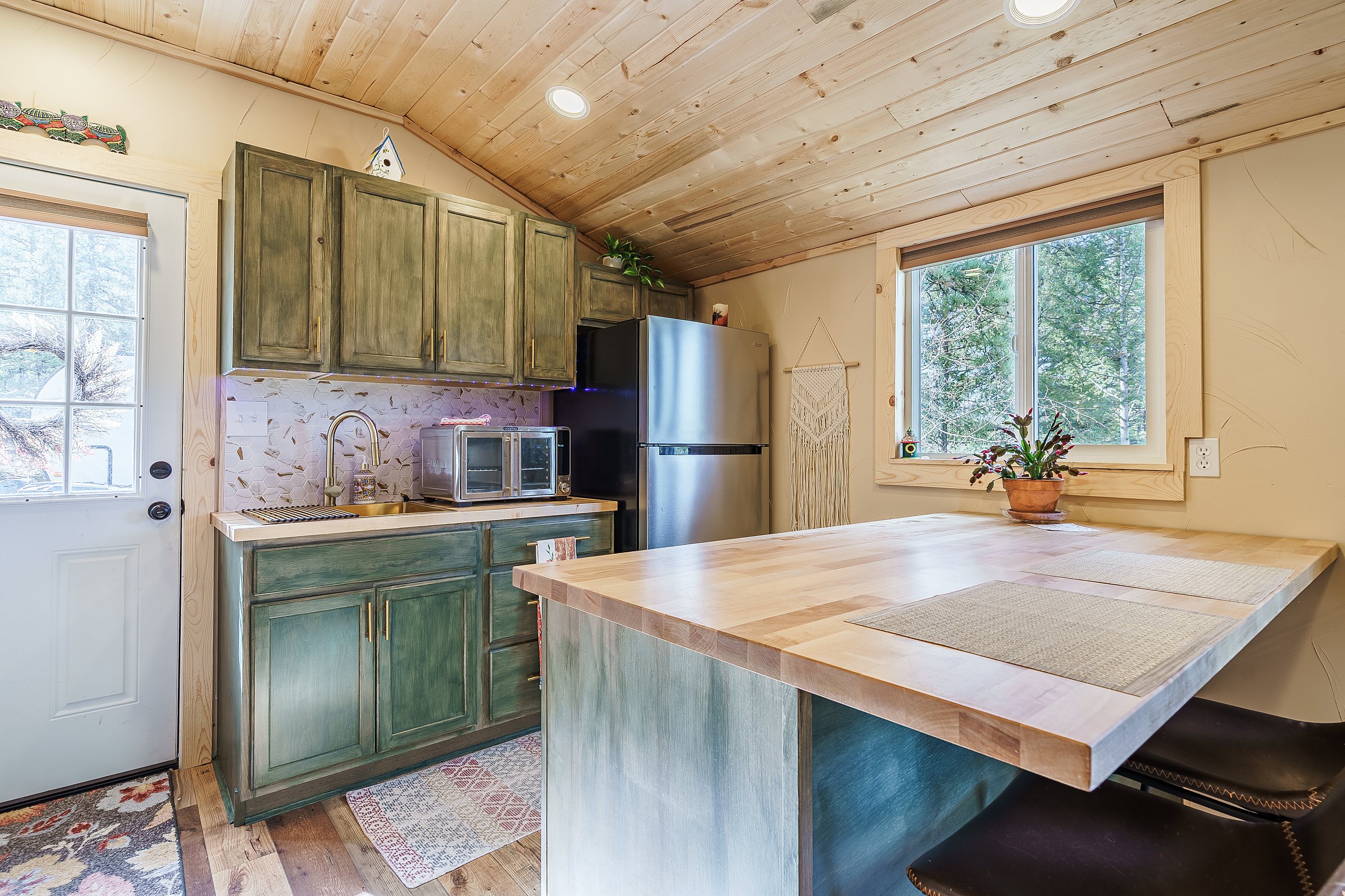 Teal kitchen island in a log cabin home