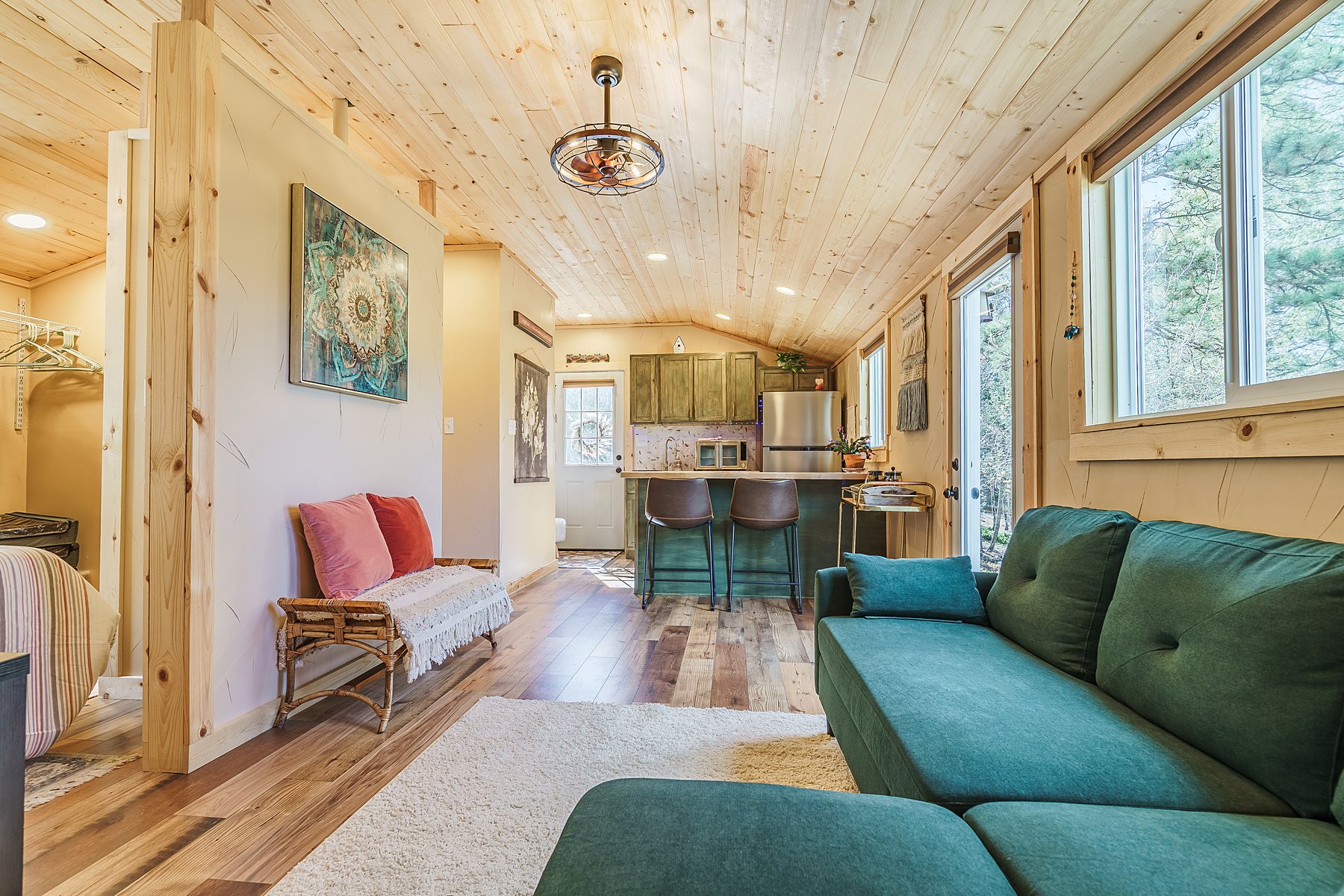 Tiny home living area with a teal sofa