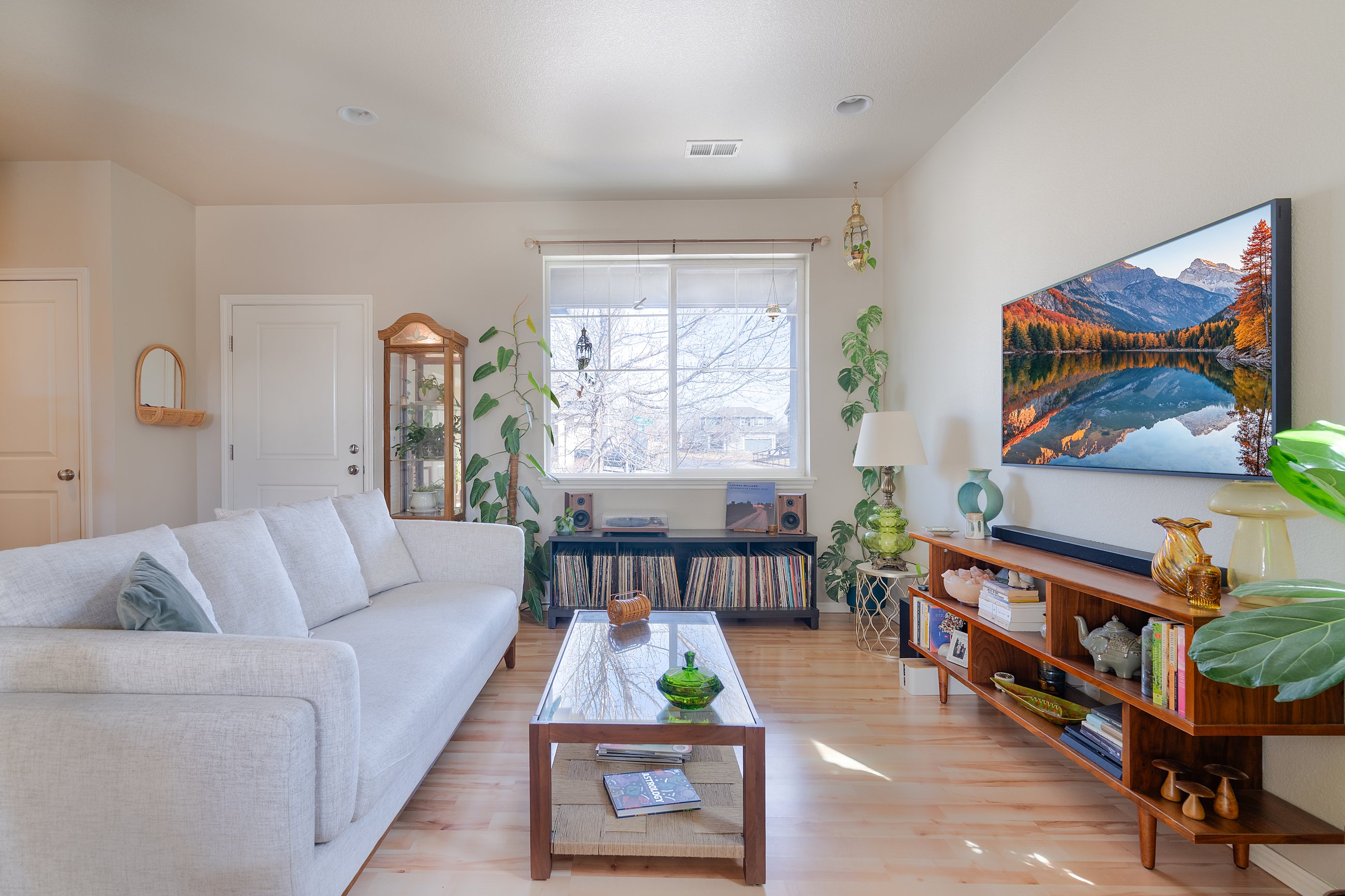 Bright open concept living room and kitchen photographed by Mirage Media