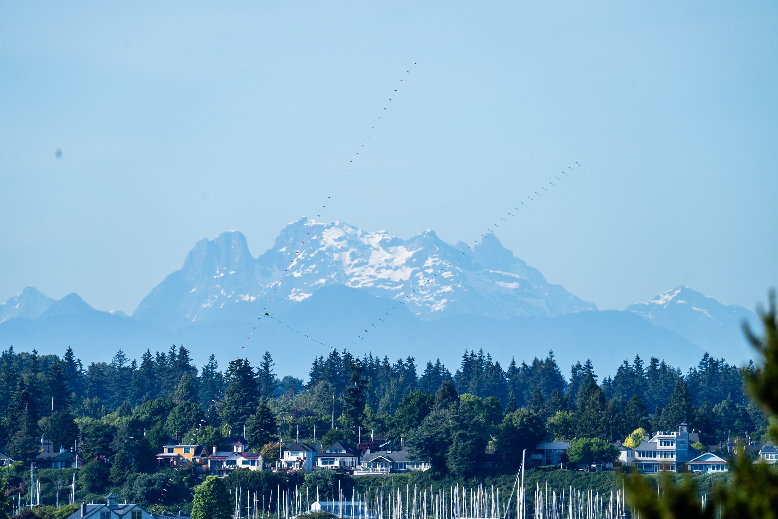 Snowcapped peaks above a Northwest Washington waterfront community